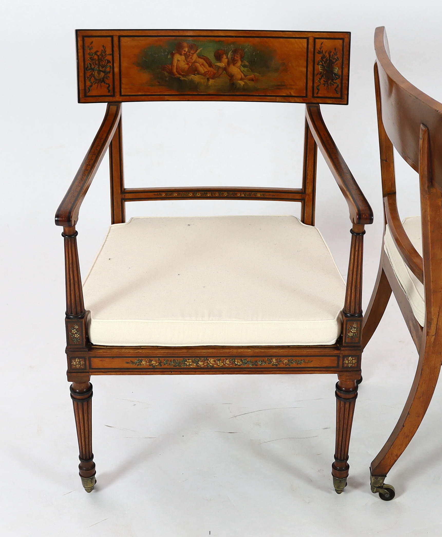 A pair of Edwardian Sheraton revival painted satinwood elbow chairs, 58cm wide, 57cm deep, 88cm high